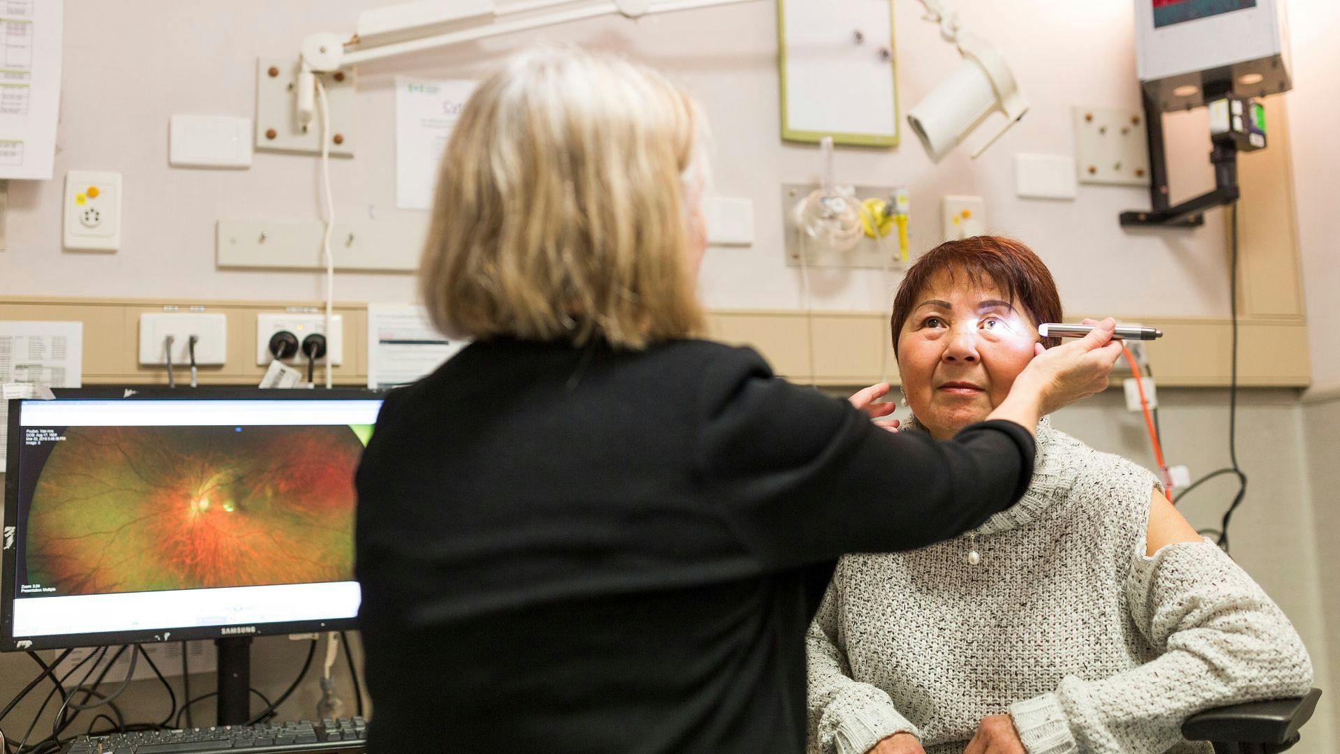 A clinician testing a patients eyes