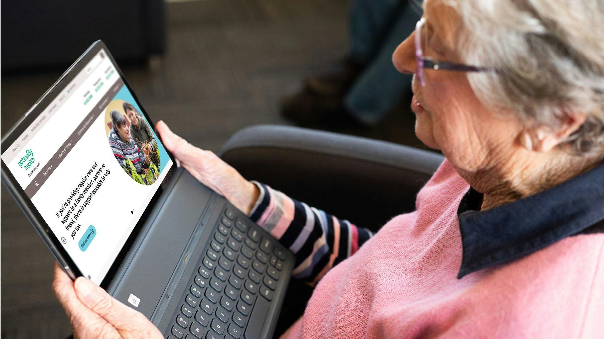 An older woman using the Gateway website on a laptop